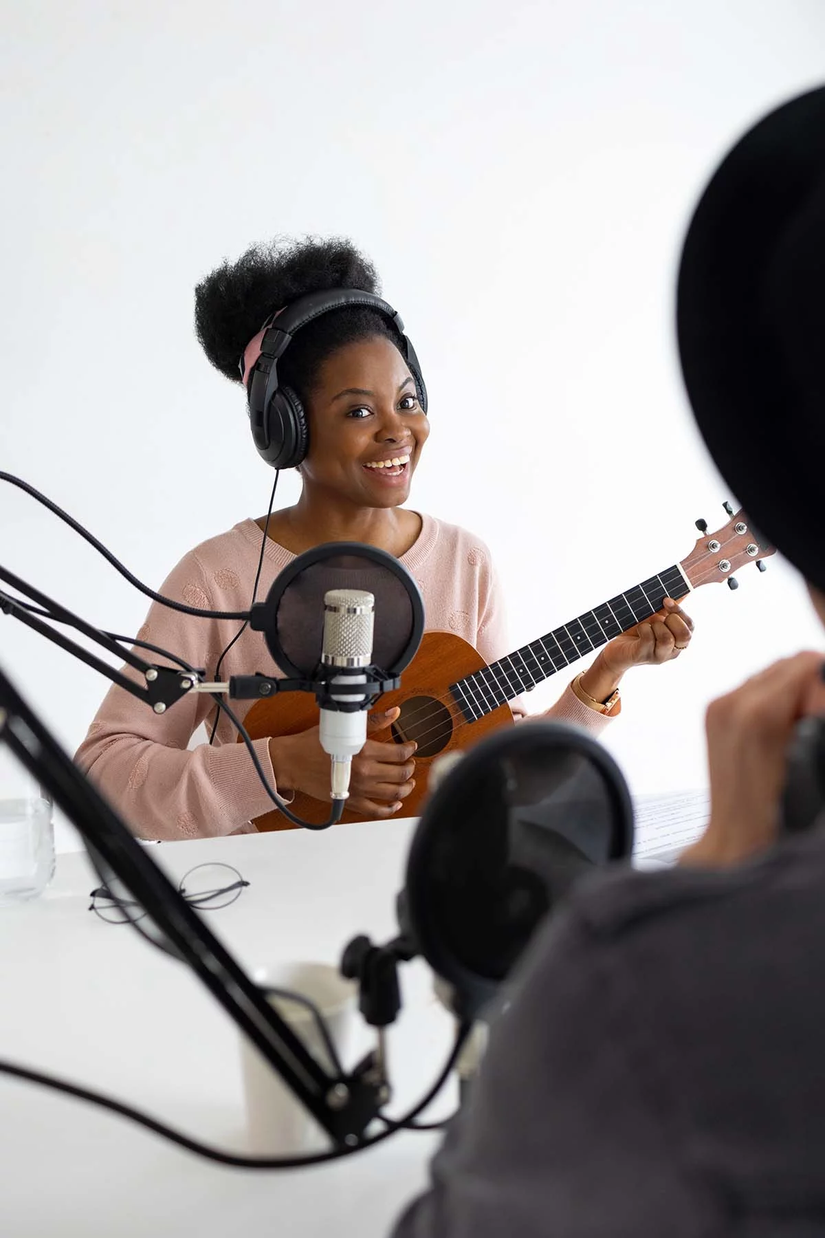 Female musician smiling singing in studio and play uszafl2.jpg