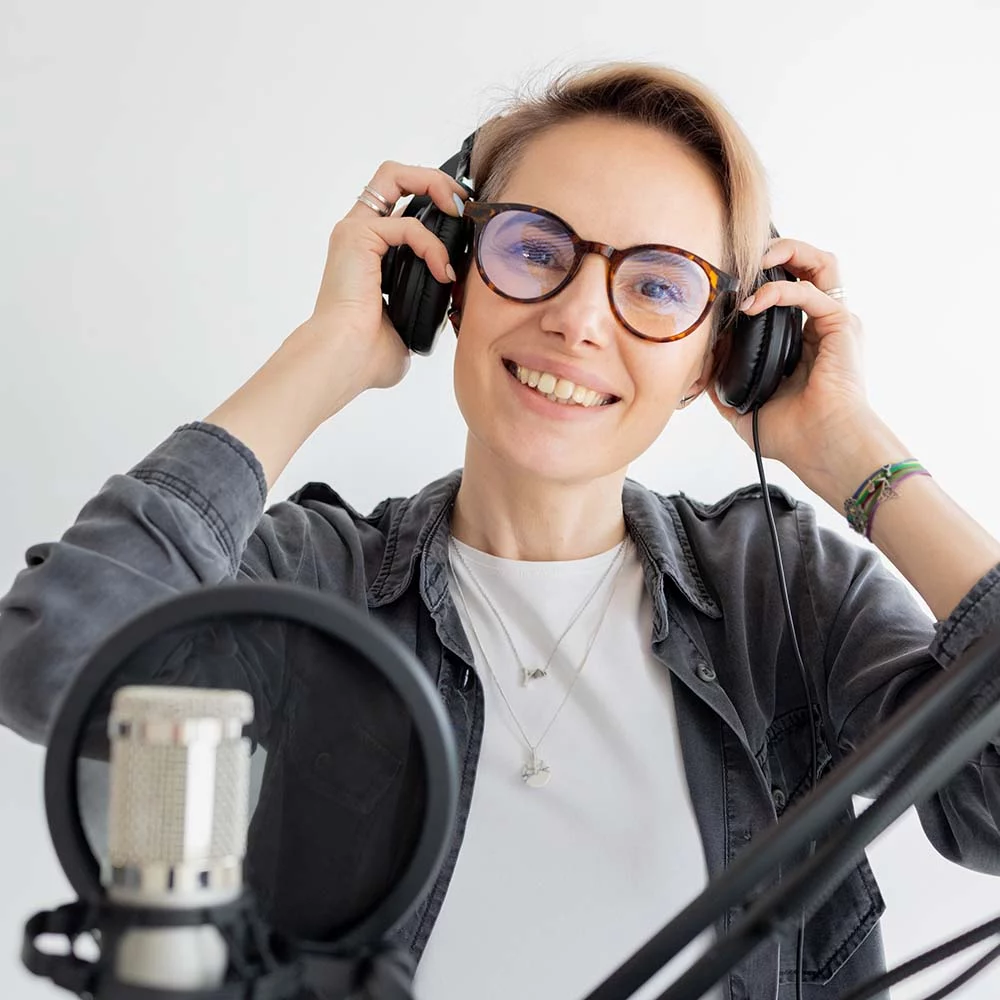 Woman puts on headphones and creates audio content vdg94nu.jpg